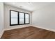 Bright bedroom showcases hardwood floors, modern recessed lighting, and a large window at 320 Dodd Ln, Alpharetta, GA 30005