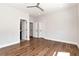 Bright bedroom with hardwood floors, ceiling fan and multiple doors at 320 Dodd Ln, Alpharetta, GA 30005