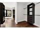 Walk-in closet with dark wood floors and custom shelving for optimal organization and storage at 320 Dodd Ln, Alpharetta, GA 30005