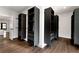 Spacious walk-in closet with multiple custom shelving units and hardwood flooring at 320 Dodd Ln, Alpharetta, GA 30005