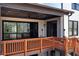 Covered back deck with sliding glass door, black ceiling fan, and wood railing at 320 Dodd Ln, Alpharetta, GA 30005
