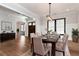 Elegant dining room with hardwood floors, modern light fixture, and a seamless flow to other living spaces at 320 Dodd Ln, Alpharetta, GA 30005
