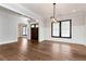 Bright dining room featuring hardwood floors, modern lighting, and easy access to the home's entrance at 320 Dodd Ln, Alpharetta, GA 30005