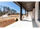 Spacious front porch with painted brick, dark columns, and a view of the charming streetscape at 320 Dodd Ln, Alpharetta, GA 30005