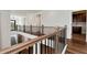 Hallway with hardwood floors, modern railing, and doorways leading to other rooms at 320 Dodd Ln, Alpharetta, GA 30005