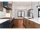Modern kitchen with a large island, stainless steel appliances, custom cabinetry, and a dining area at 320 Dodd Ln, Alpharetta, GA 30005