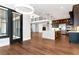 Open-concept kitchen with a large island, stainless steel appliances, and hardwood floors throughout the area at 320 Dodd Ln, Alpharetta, GA 30005