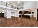 Open-concept living room with hardwood floors, balcony and dark wood kitchen cabinets at 320 Dodd Ln, Alpharetta, GA 30005