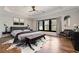 Elegant main bedroom with tray ceiling, hardwood floors, and large windows for ample natural light at 320 Dodd Ln, Alpharetta, GA 30005