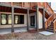 Covered patio featuring brick siding, concrete floor, and access to backyard at 320 Dodd Ln, Alpharetta, GA 30005