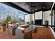 Covered patio with fireplace, ceiling fan, and comfortable seating at 320 Dodd Ln, Alpharetta, GA 30005