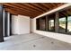 Covered patio featuring concrete flooring, painted brick, and black support beams at 320 Dodd Ln, Alpharetta, GA 30005
