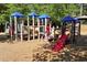 Image presents a colorful playground with slides, tunnels, and climbing structures atop a wood chip safety surface at 320 Dodd Ln, Alpharetta, GA 30005
