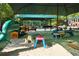 A playground showcases a dinosaur spring rider, picnic tables, and other play equipment on a sand-filled surface at 320 Dodd Ln, Alpharetta, GA 30005