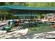 Photo shows a playground featuring covered play areas, swings, and various play structures on a sandy surface at 320 Dodd Ln, Alpharetta, GA 30005