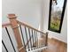 Staircase features natural wood steps, black metal railings, and a large window for natural light at 320 Dodd Ln, Alpharetta, GA 30005
