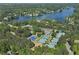 Aerial shot of numerous well-maintained tennis courts, surrounded by lush trees, with the lake in the distance at 320 Dodd Ln, Alpharetta, GA 30005