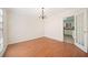 Dining room with wood floors and a chandelier. Doorway to the kitchen at 4401 Shiloh Hills Dr, Snellville, GA 30039