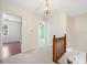 Upstairs hallway with hardwood flooring and a view into bedrooms at 4401 Shiloh Hills Dr, Snellville, GA 30039