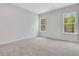 Light-filled bedroom featuring neutral carpeting, soft grey paint, and windows for natural light at , Mcdonough, GA 30253