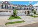 Charming townhome featuring a two-car garage, gray siding, and manicured lawn at , Mcdonough, GA 30253