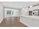Open-concept kitchen with white cabinets, stainless steel appliances, and island at , Mcdonough, GA 30253