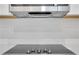 Close-up of a stainless steel stove top with a range hood above it at , Mcdonough, GA 30253