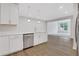 Spacious kitchen with white cabinets, stainless steel dishwasher, and hardwood floors at , Mcdonough, GA 30253