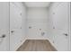Empty laundry room with vinyl flooring and built-in shelving at , Mcdonough, GA 30253