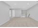 Open loft area featuring neutral walls, carpet, and a staircase with decorative railing at , Mcdonough, GA 30253