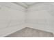 Spacious walk-in closet featuring ample storage with wire shelving and neutral carpet at , Mcdonough, GA 30253