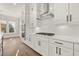 Modern kitchen showcasing white cabinets, a stainless steel range hood, and sleek appliances at 1005 Coleman Place Dr, Roswell, GA 30075