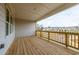 Spacious back porch with wood flooring and railings, perfect for outdoor relaxation and enjoying the neighborhood view at 4814 Floydwood Ln, Mableton, GA 30126