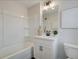 Bathroom features a shower-tub, single sink vanity with black hardware, and decorative art at 4814 Floydwood Ln, Mableton, GA 30126