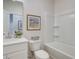 Clean bathroom with shower-tub combo, white vanity, and neutral wall art at 4814 Floydwood Ln, Mableton, GA 30126