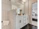 Modern bathroom with double sink vanity, black hardware, walk-in shower and sleek black tile floors at 4814 Floydwood Ln, Mableton, GA 30126
