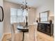 Dining room with modern chandelier, dark wood table, and lots of natural light at 4814 Floydwood Ln, Mableton, GA 30126