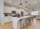 Bright kitchen with stainless appliances, white cabinetry, quartz counters, and stylish pendant lighting over a large island at 4814 Floydwood Ln, Mableton, GA 30126