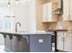 Kitchen island with pendant lights and stainless steel appliances at 4814 Floydwood Ln, Mableton, GA 30126