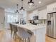 Bright kitchen features a large island, stainless steel appliances, pendant lighting and hardwood floors at 4814 Floydwood Ln, Mableton, GA 30126