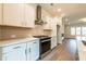 Well-lit kitchen with stainless steel appliances and a view of the living room at 4814 Floydwood Ln, Mableton, GA 30126