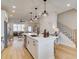 Open-concept kitchen with stainless appliances, island with bar seating, and hardwood floors at 4814 Floydwood Ln, Mableton, GA 30126