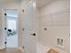 Hallway access to a laundry room with storage, white walls and plenty of space at 4814 Floydwood Ln, Mableton, GA 30126