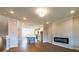 Open living space with kitchen, living, and dining areas and contemporary fireplace at 4814 Floydwood Ln, Mableton, GA 30126