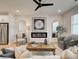 Open-concept living room featuring a fireplace, hardwood floors, and comfortable seating at 4814 Floydwood Ln, Mableton, GA 30126