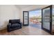 Balcony view with arm chair, small patio table, chairs, and a cityscape at 560 John Wesley Dobbs Ave, Atlanta, GA 30312