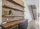 Charming bar area with brick accent wall, wooden shelves, and built-in cooler at 560 John Wesley Dobbs Ave, Atlanta, GA 30312