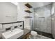 Bathroom featuring a walk-in shower and wooden shelves for storage at 560 John Wesley Dobbs Ave, Atlanta, GA 30312
