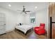 Bright bedroom features a ceiling fan and a red armchair, offering a relaxing retreat at 560 John Wesley Dobbs Ave, Atlanta, GA 30312