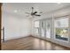 Bright bedroom featuring a ceiling fan, hardwood floors, and French doors leading to an outdoor balcony at 560 John Wesley Dobbs Ave, Atlanta, GA 30312